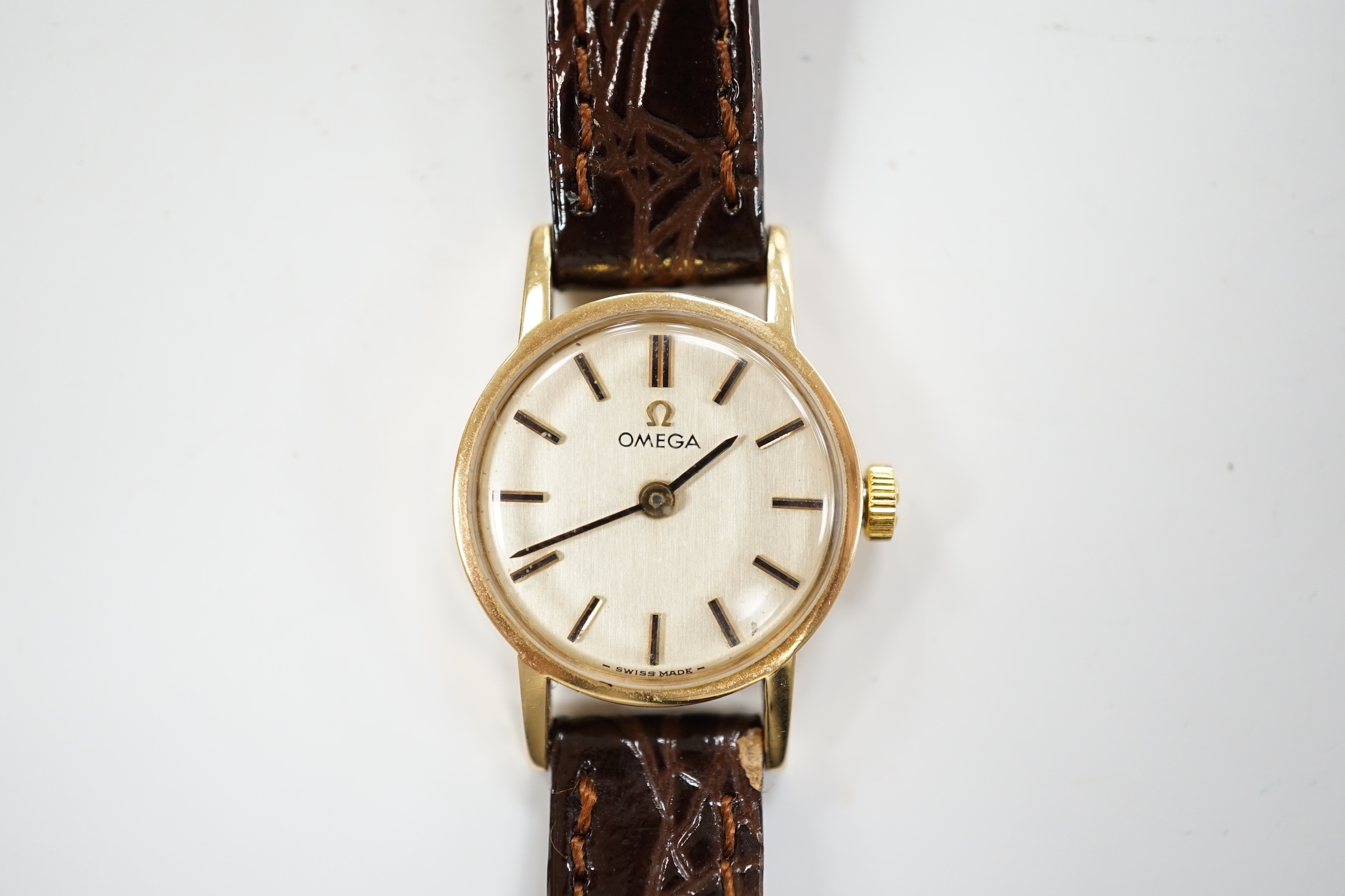 A lady's 1970's 9ct gold Omega manual wind wrist watch, with case back inscription, on associated leather strap, in Garrards box.